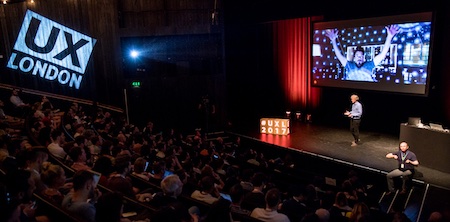 The audience at UX London, captivated by a speaker on stage.